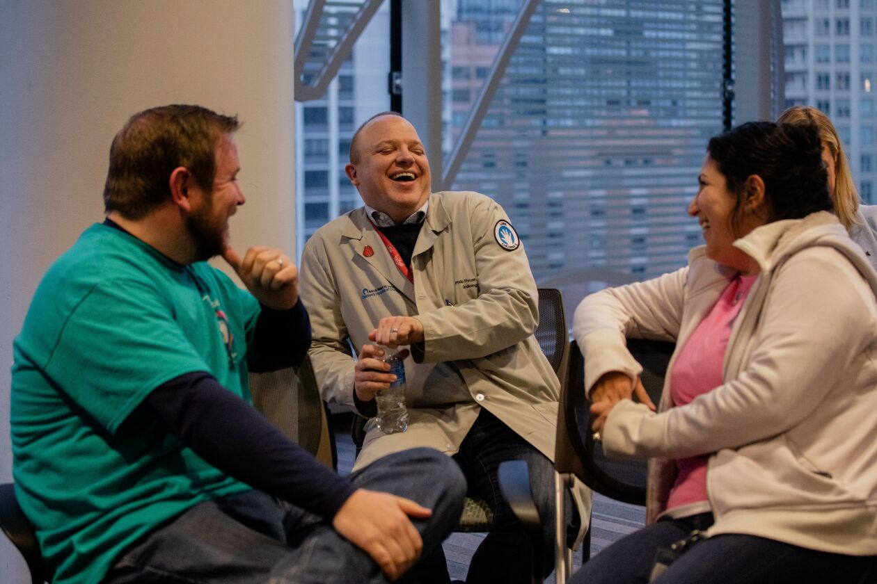 Dr. Philip Thrush, chats with Brian Donnelly and Lisa Donnelly on Friday.